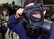 A customer tries on a gas mask