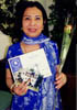 Helene holds her Manicuists graduation diploma.