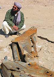 Noor Ahmad Azimy and destroyed de-mining equipment